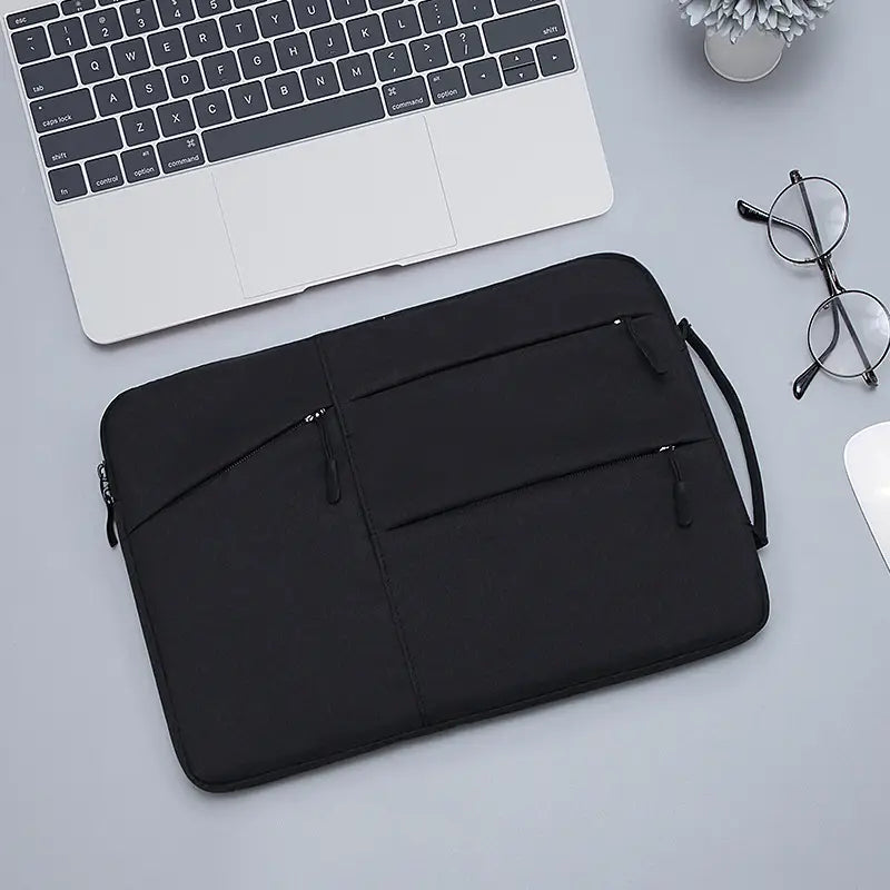 Black laptop sleeve bag with multiple zippered compartments and carrying handle designed for Macbook Air and Pro models.