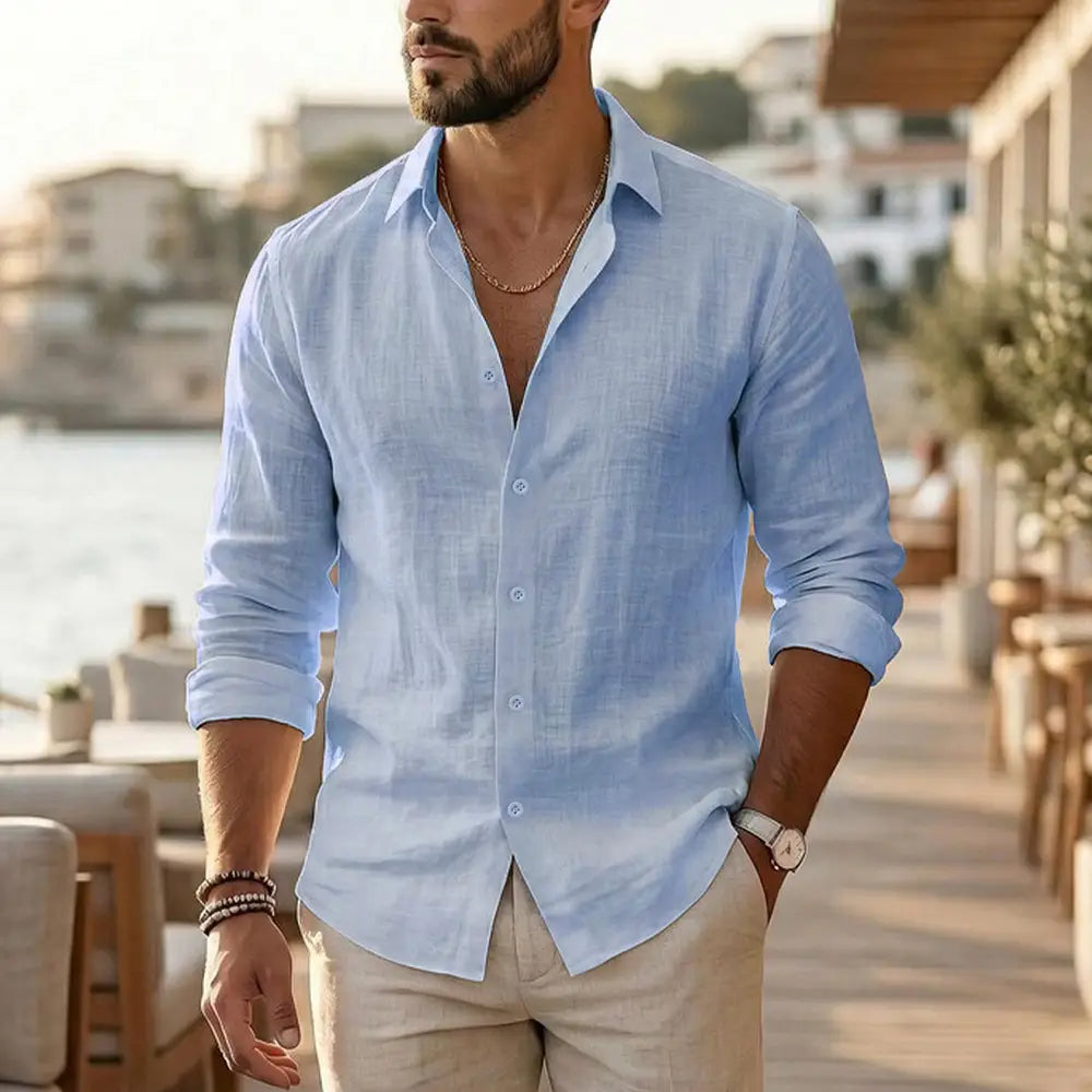 Light blue cotton linen mens long sleeve casual shirt with button-down front and rolled-up sleeves.