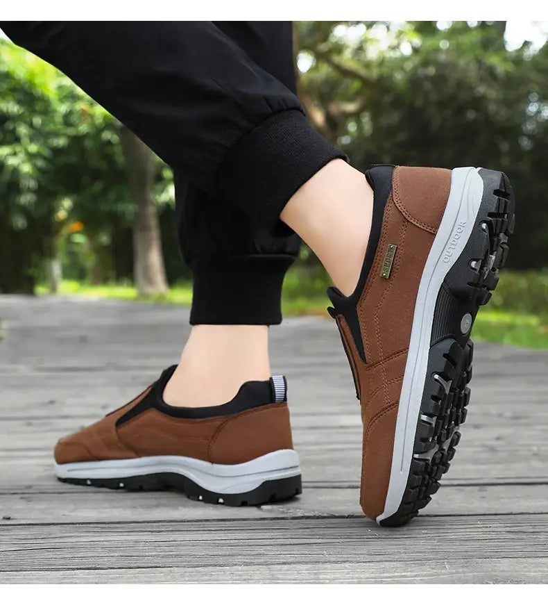 Men orthopedic slip-on walking shoes in brown and black with a rugged rubber sole designed for hiking and outdoor use.