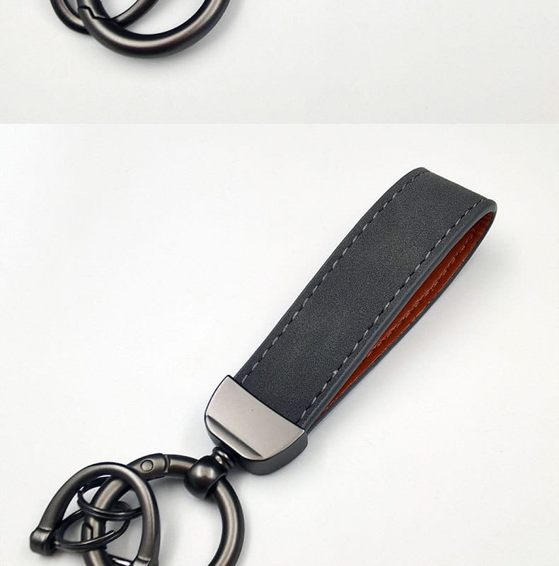 Genuine leather keychain 5-pack featuring black leather with a matte finish, contrasting brown interior stitching, and a sleek metal clasp with an interlocking ring design.