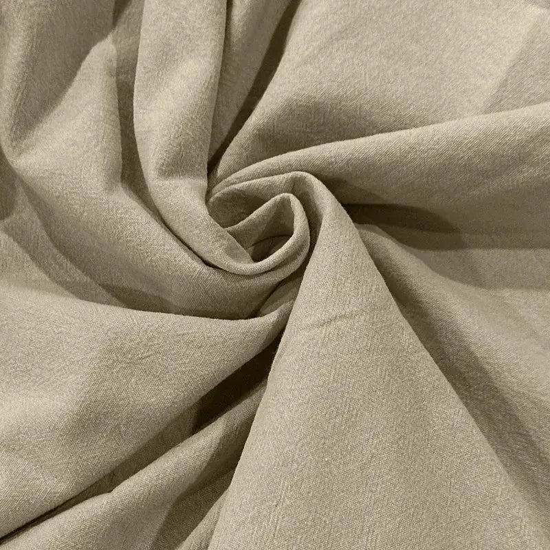 Beige cotton linen hooded henley shirt fabric with a soft textured weave and gentle folds.