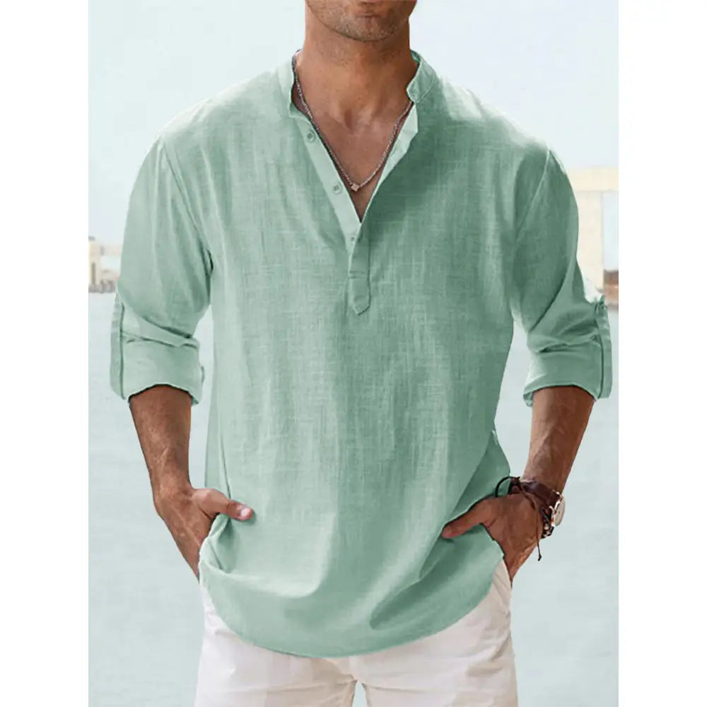 Men’s light green long sleeve casual shirt made of cotton linen featuring a buttoned placket and rolled cuffs.