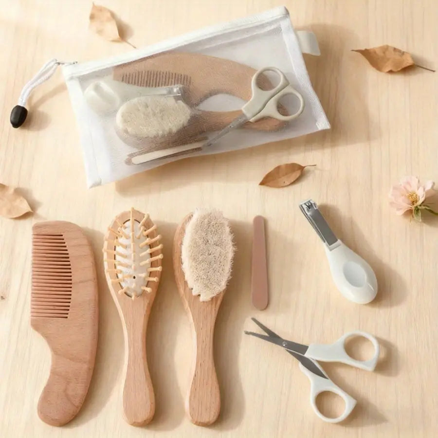 Natural wood baby grooming set with soft bristles and rounded handles in a clear zippered pouch for storage.