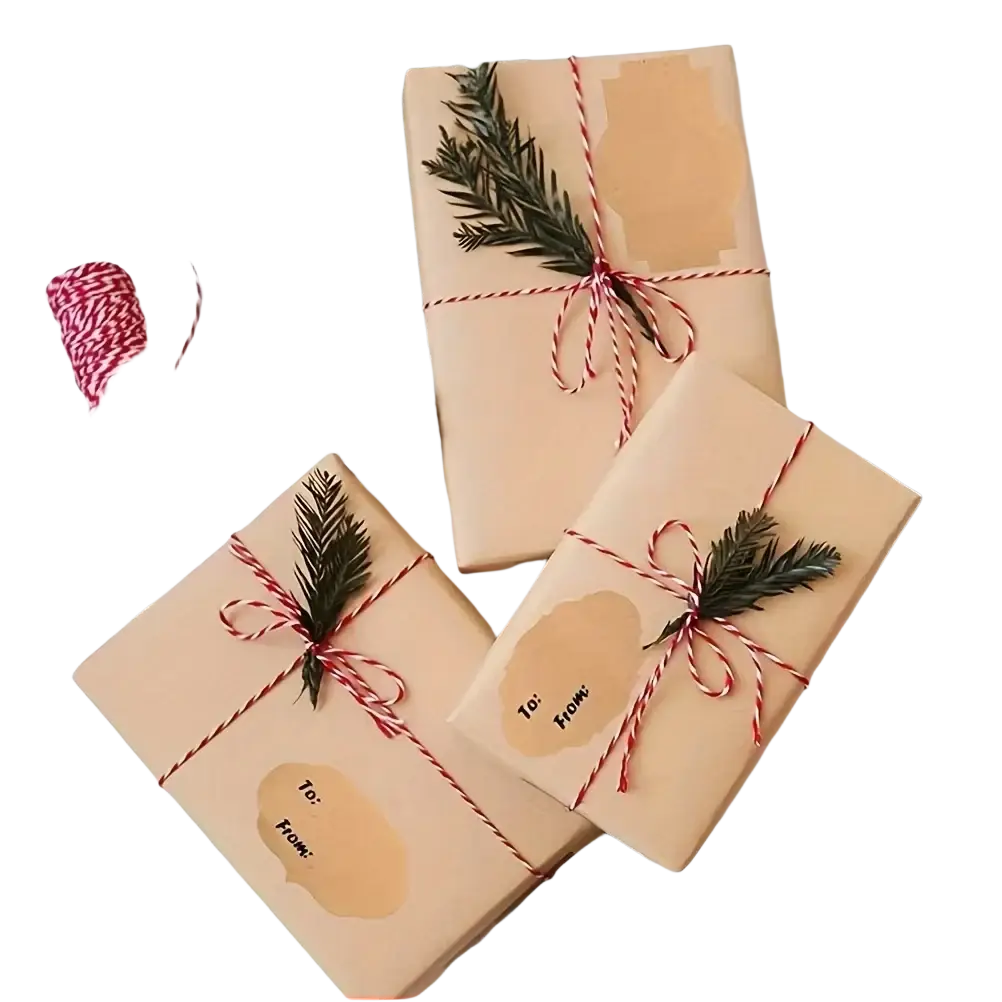 Three beige gift boxes wrapped with red and white twine and pine sprigs featuring adhesive paper stickers for christmas decorations