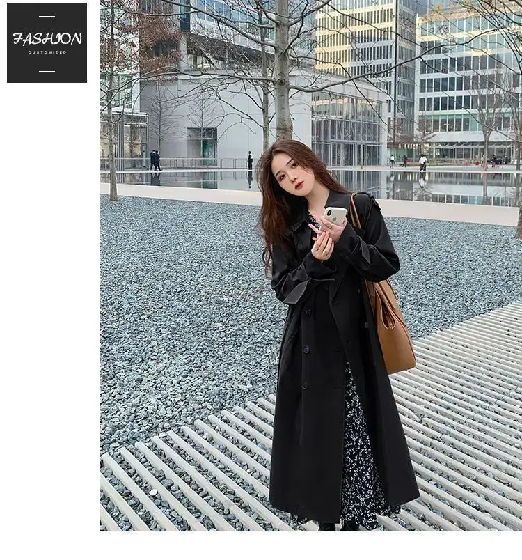 Black women double-breasted trench coat with a classic design and subtle texture ideal for casual windbreaker wear.
