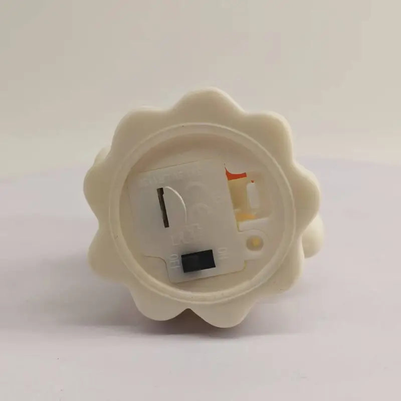 Off-white plastic flower-shaped led lamp with visible internal circuit board and battery compartment shown from the back for Halloween pumpkin ghost night light ornament.