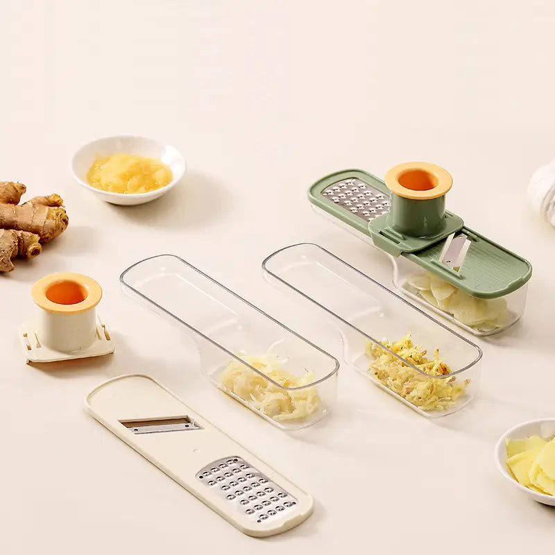 Hachoir à ail multifonction en acier inoxydable, coupe-légumes avec lames interchangeables et bacs en plastique transparent, dans une conception vert et blanc, pour un broyage efficace de l’ail.