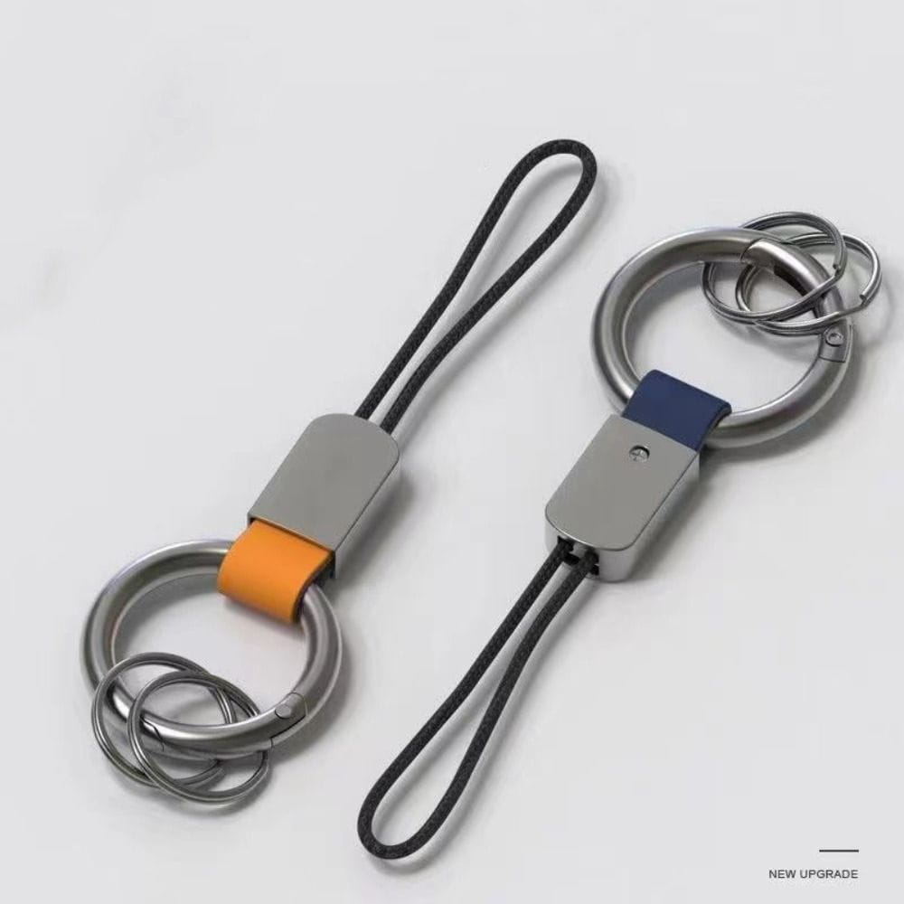 Two leather braided carabiner keychains with an orange leather strap and a blue fabric accent featuring sleek metallic rings and black cord loops.