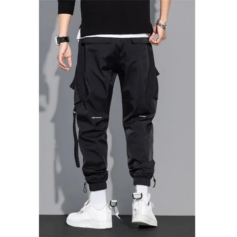 black cargo pants with multiple pockets and elastic cuffs featuring a sleek modern design ideal for mens tactical streetwear use