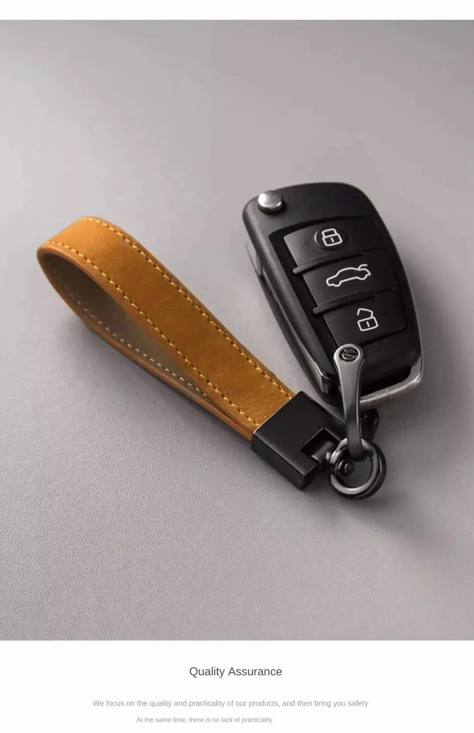 Tan suede leather car keychain ring with tan leather key fob and black metal clasp and ring designed to fit a modern car remote.