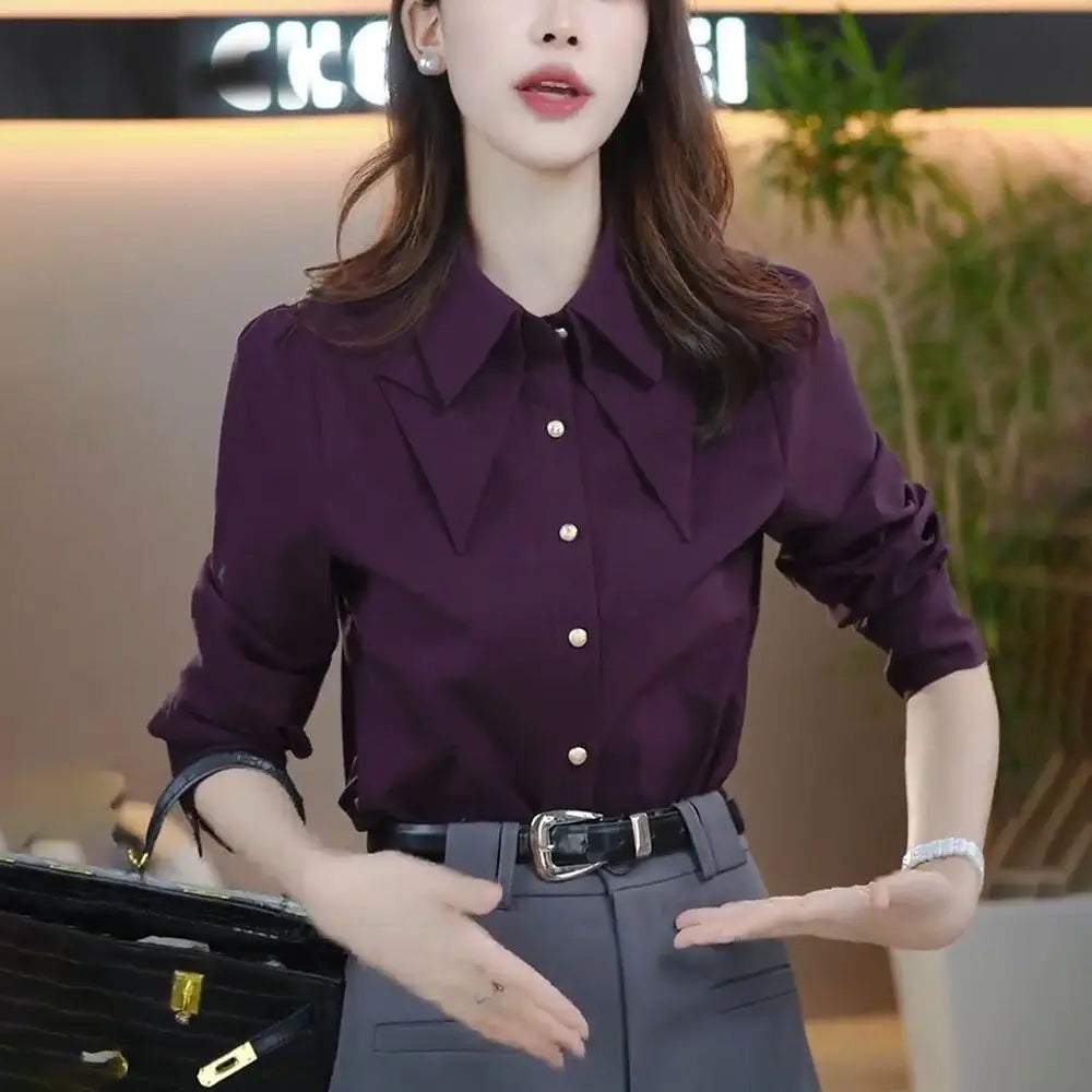a sleek deep purple satin blouse long sleeve button top featuring a classic collar and subtle ruffled detailing at the neckline modname=ckeditor