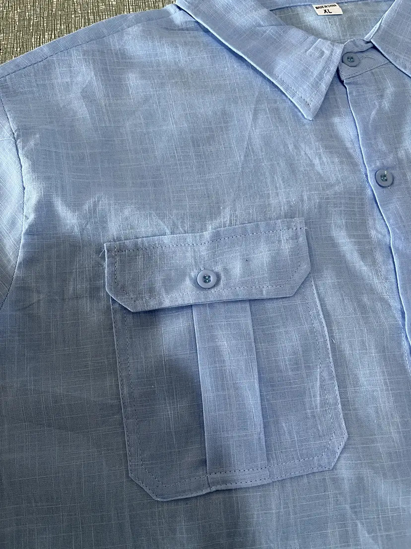 Men linen short sleeve shirt in light blue with a subtle grid pattern and a single-button chest pocket ideal for casual summer wear.
