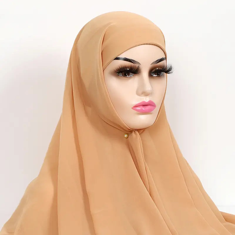 Beige instant chiffon hijab with cap bonnet featuring soft flowing fabric and subtle gold accent at the neckline.