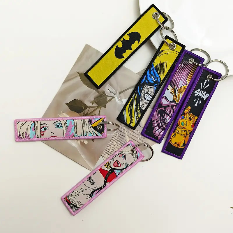 colorful embroidered rectangular keychains featuring comic book characters batman harley quinn and the infinity gauntlet from the superhero embroidered keychain set anime key lanyard