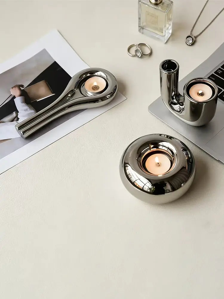silver ceramic sphere candle holders made of shiny silver metallic material with sleek modern designs for decorative use