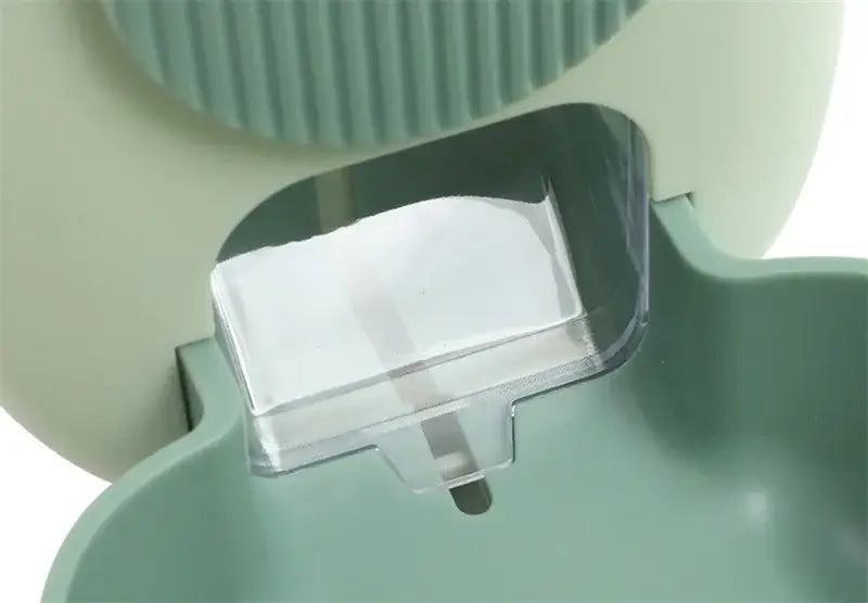 a translucent white soap bar in a clear plastic holder inside a mint green silicone toothbrush case illustrating food storage with high-quality plastic materials