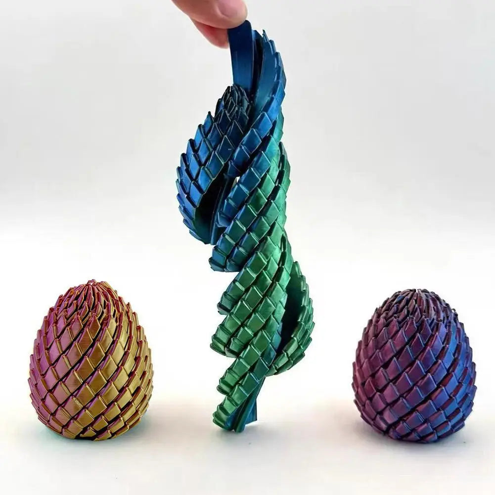 A spiraling iridescent blue and green articulated dragon egg fidget toy with a woven pattern and metallic finish viewed from the front.