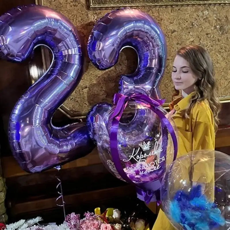 32 inch purple metallic number 23 birthday party balloon featuring a clear balloon tied at the bottom with cursive text and a crown design.