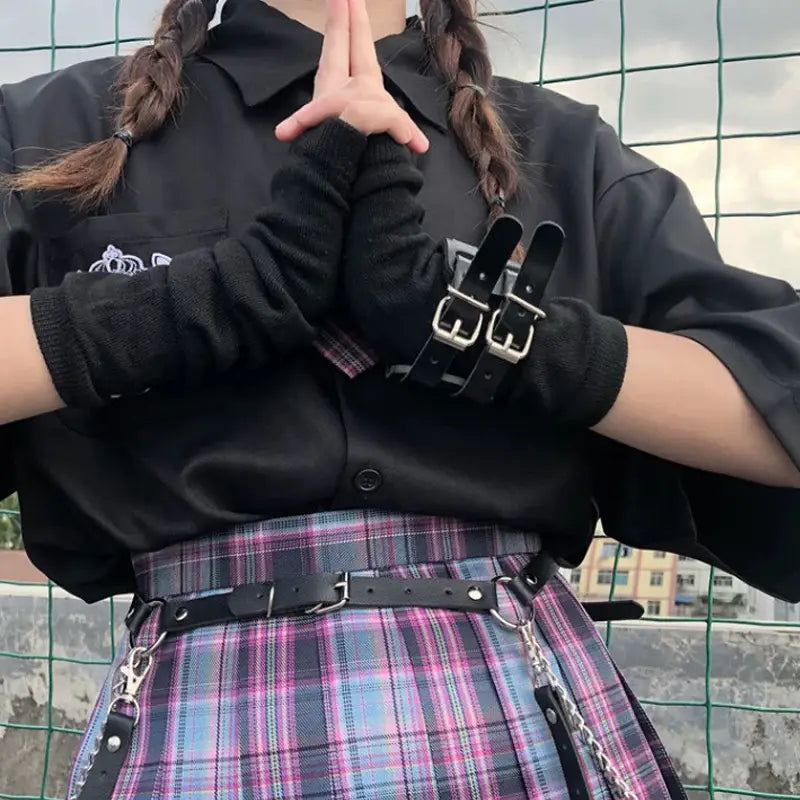 black leather wrist cuffs with silver toned buckles and adjustable straps providing durable and stylish arm accessories