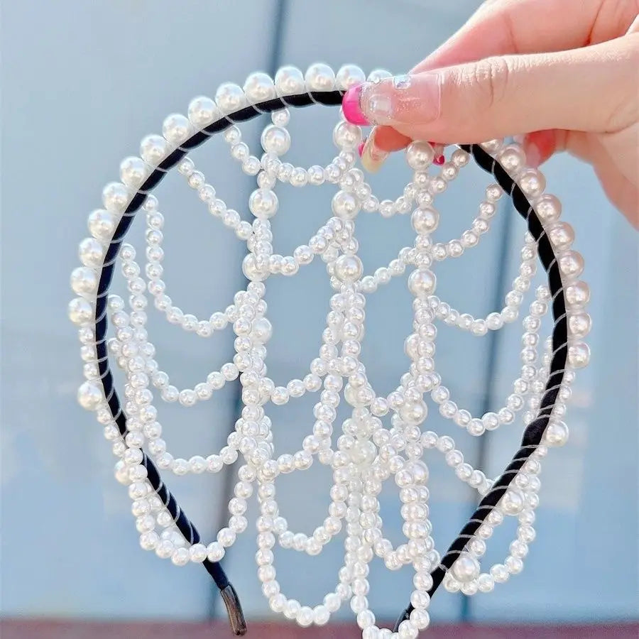 A delicate white pearl bridal crown hair band with a black elastic band and an intricate beaded design suitable as an elegant tassel headpiece.