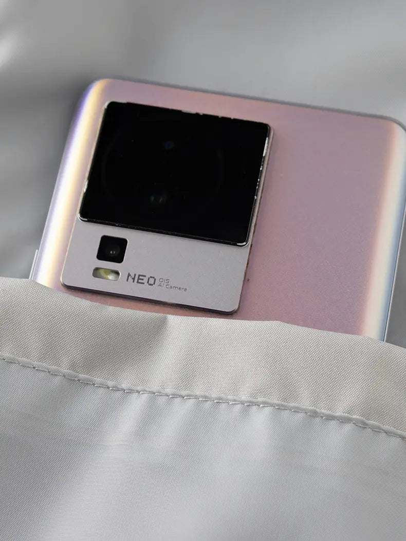 a sleek rose gold xiaomi neo 5g smartphone showing the back with a prominent square camera module alongside a windbreaker waterproof hiking jacket men windbreaker designed for autumn use