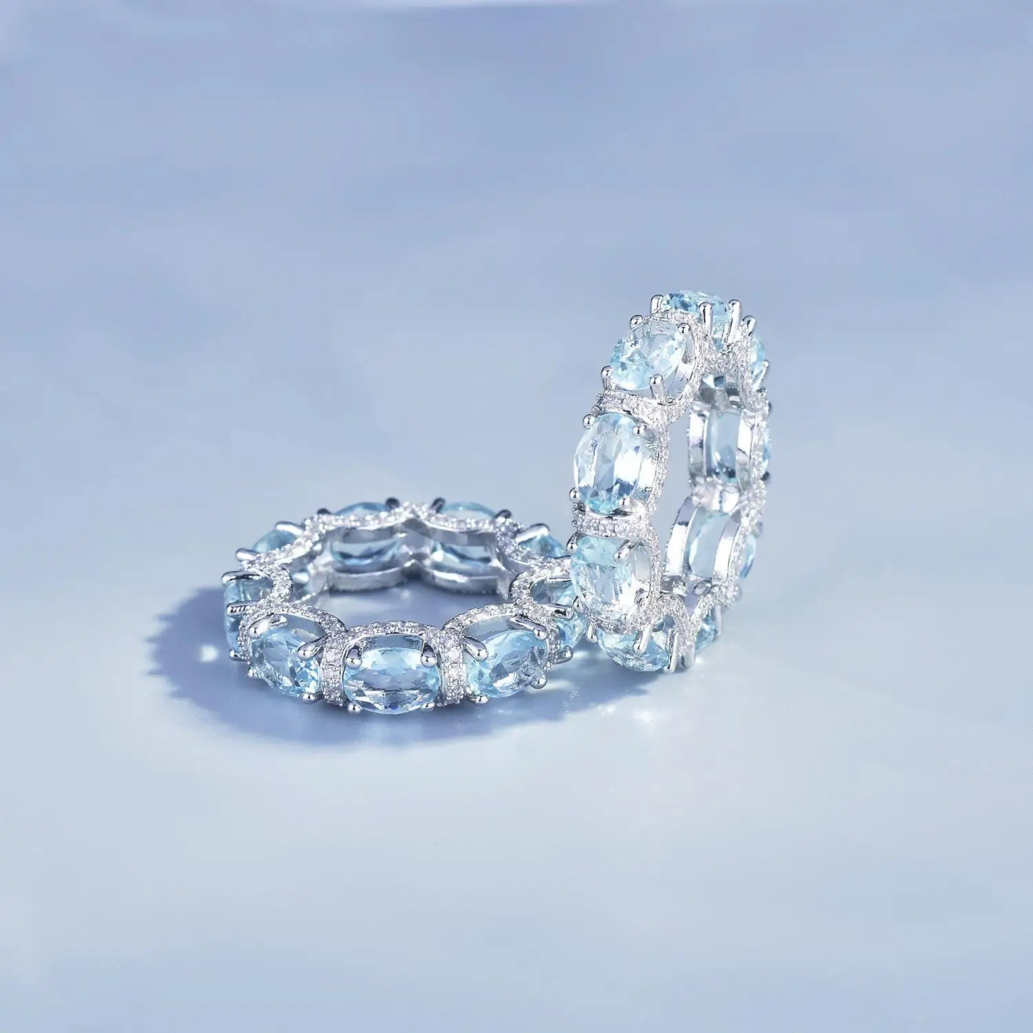 Elegant oval-cut aquamarine eternity band ring set in sleek silver-toned metal with sparkling accent stones from the Aquamarine Crystal Bridal Jewelry Set.