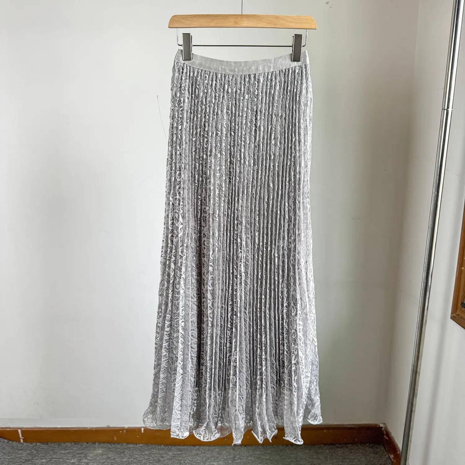 A shimmering silver high waist pleated midi skirt with delicate lace overlay and elastic waistband suitable for Y2k streetwear.