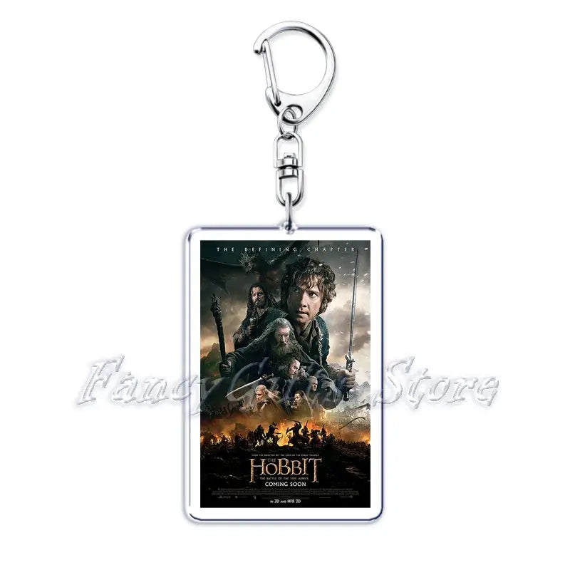 Silver rectangular acrylic keychain featuring a printed movie poster for the hobbit the defining chapter with characters in dark dramatic attire against an orange and black battlefield backdrop from the movie poster acrylic keychain set.