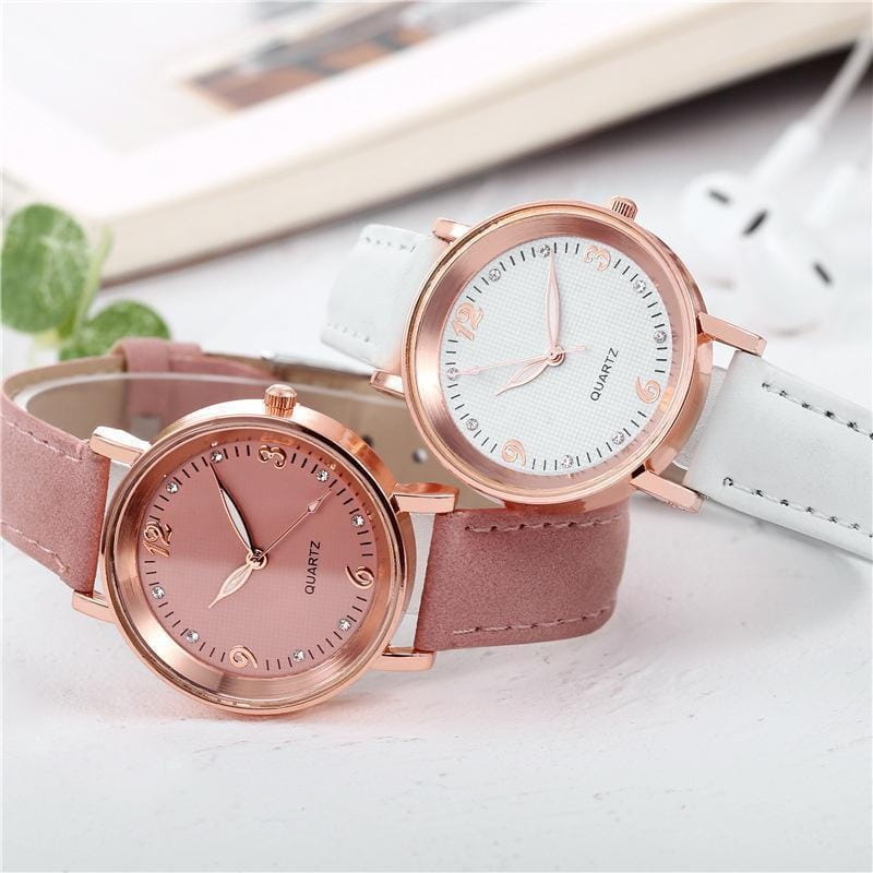 women quartz watch with a rose gold case and pink leather band featuring a light-colored dial adorned with small sparkling crystals.