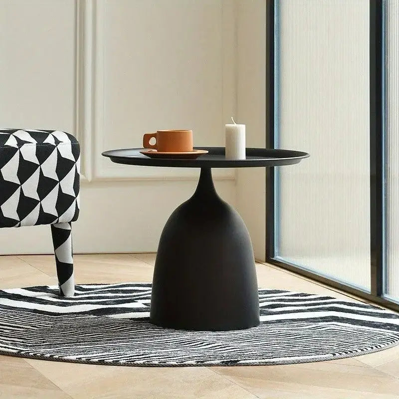 black matte-finished modern coffee table with a sleek bulbous base and circular top ideal for living room use