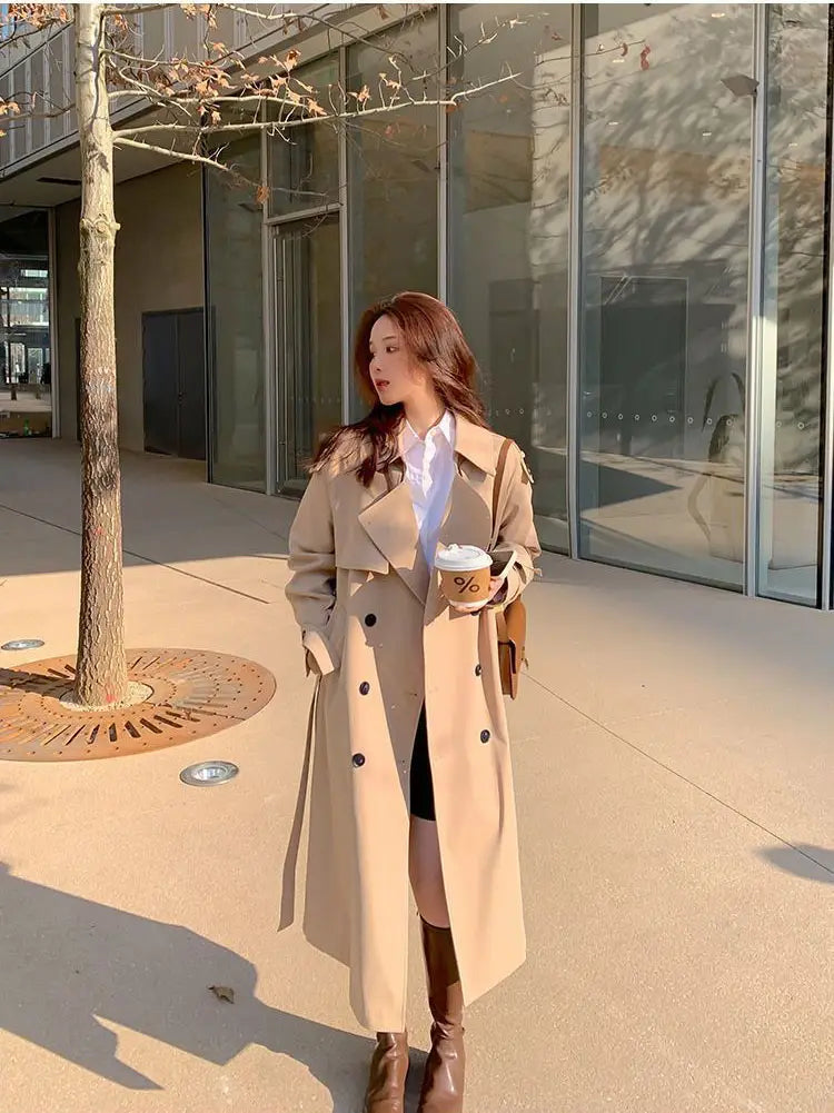 beige women double breasted trench coat featuring black buttons and a classic double-breasted design suitable for formal and casual wear