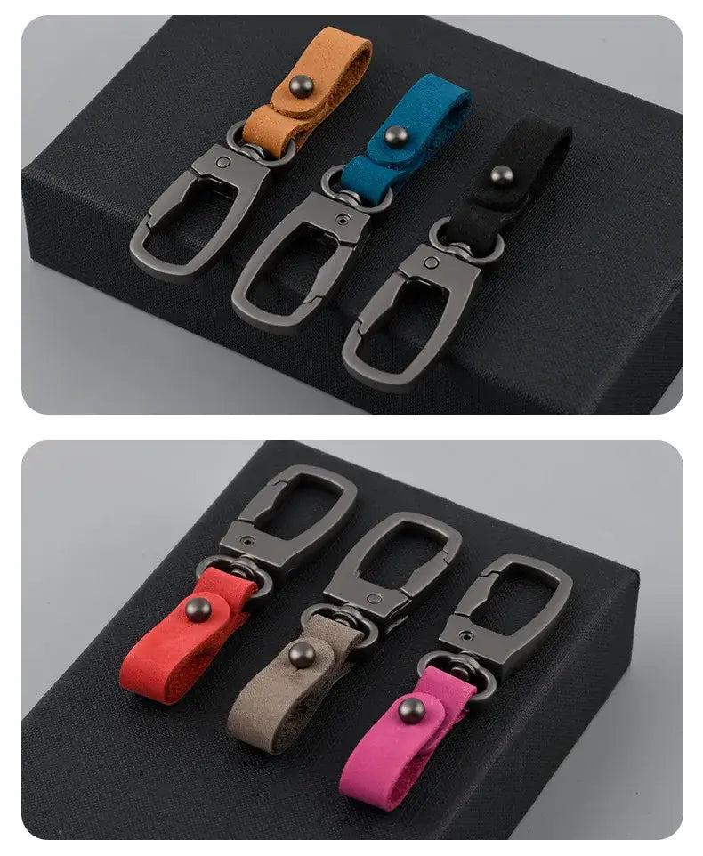 Set of five leather keychain car key holder organizer charms with metallic carabiner clips in orange blue black red and pink.