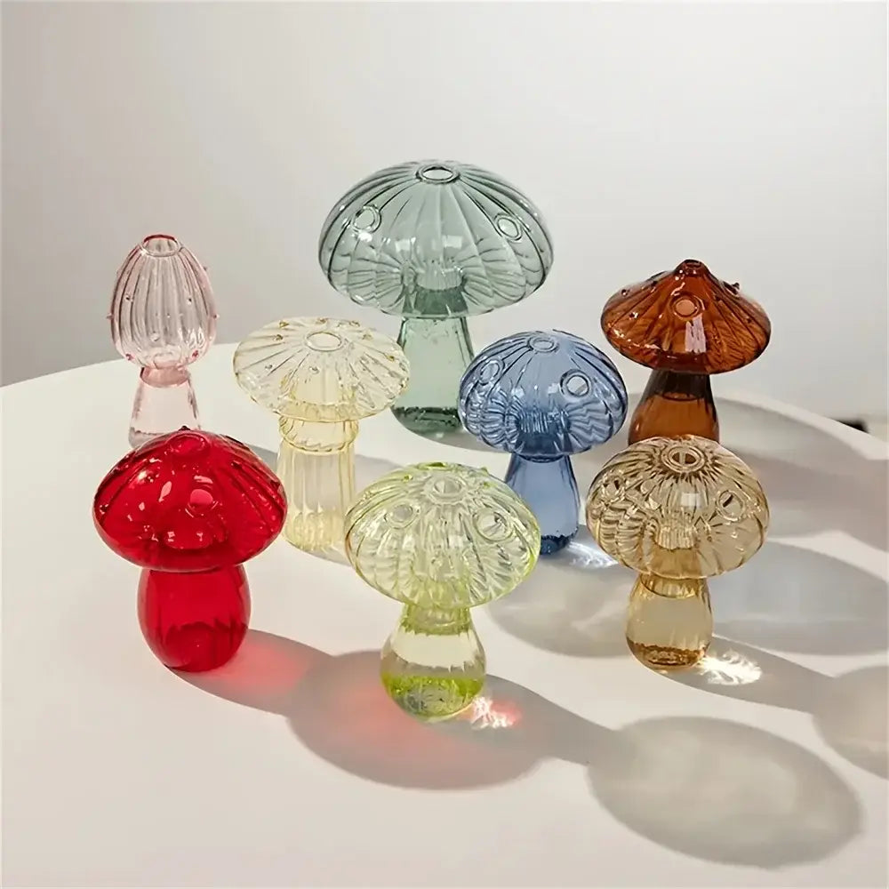 A collection of colorful translucent glass mushroom bud vases in various hues including red green blue yellow and amber designed as nordic plant holders.
