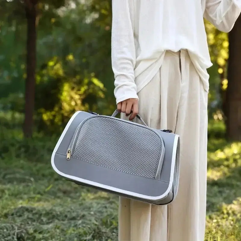 Sac bandoulière de transport pour animaux en maille respirante gris, avec bordure blanche, panneau avant en maille et poignée robuste pour un transport aisé.