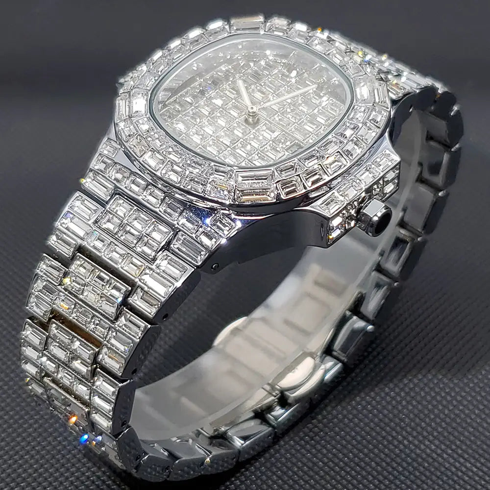 A dazzling iced out diamond quartz watch for men with a silver stainless steel band and case featuring an intricate grid pattern of clear stones on the face.