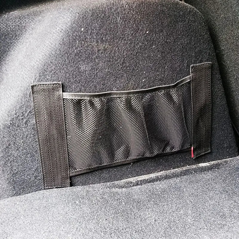 Schwarzer Kofferraum-Organizer aus Netzgewebe mit elastischen Seitenpaneelen und rotem Reißverschluss-Zug; ausgelegt für elastische Netzaufbewahrung und -organisation.