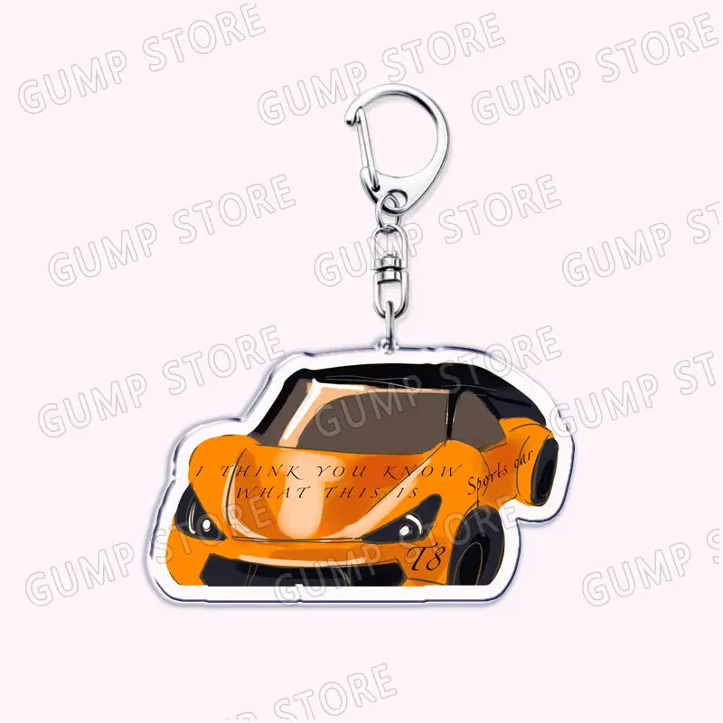 Orange and black acrylic Tate Mcrae sports car keychain with a silver metal clip designed as a music fan gift.