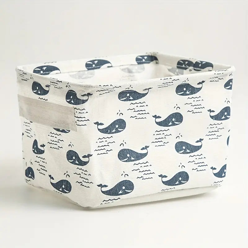 Panier de rangement pliable en tissu blanc avec des motifs de baleine et d’ondes bleu marine, pour un usage comme panier de rangement ou boîte de rangement