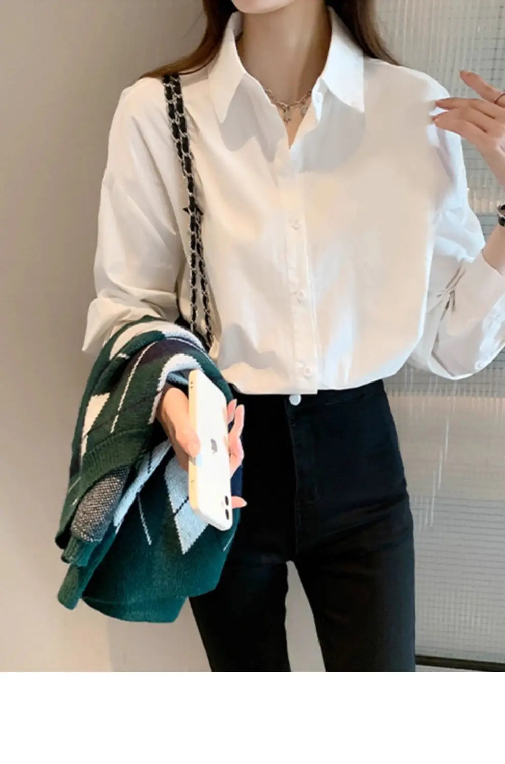 Solid white basic shirt with long sleeves button-down front classic collar and subtle texture for casual oversized wear