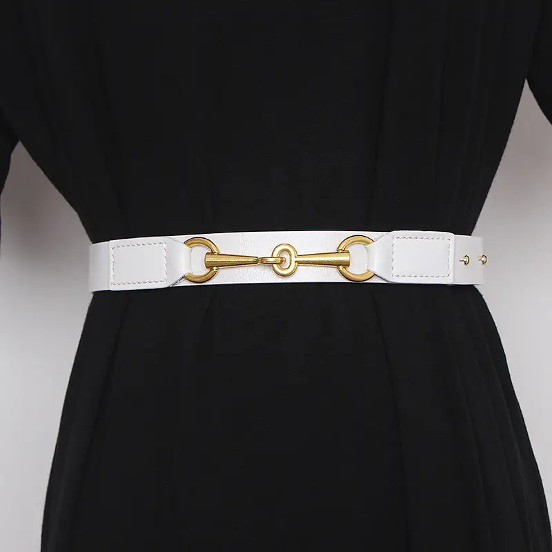 White leather women leather belt with gold-tone horsebit buckle displayed on front side.
