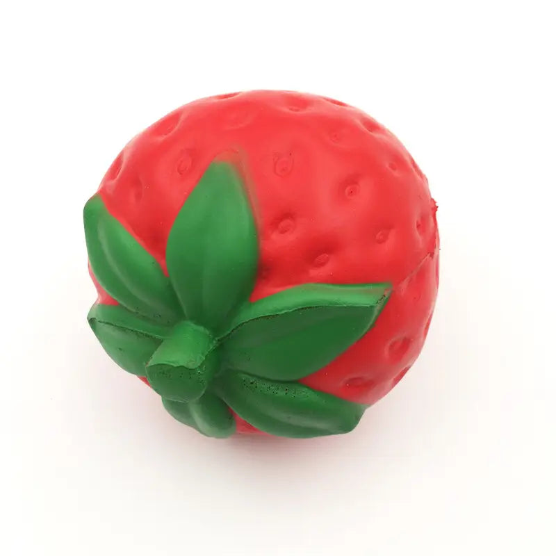 Juguete antiestrés de fresa roja con forma de fresa, que se eleva lentamente y es blandamente esponjoso, hecho de silicona suave, con una parte superior de hojas verdes.