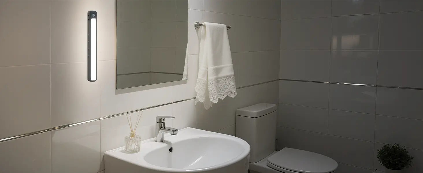 white ceramic sink with sleek chrome faucet illuminated by motion sensor light bar made of iron sheet for rechargeable under cabinet lighting