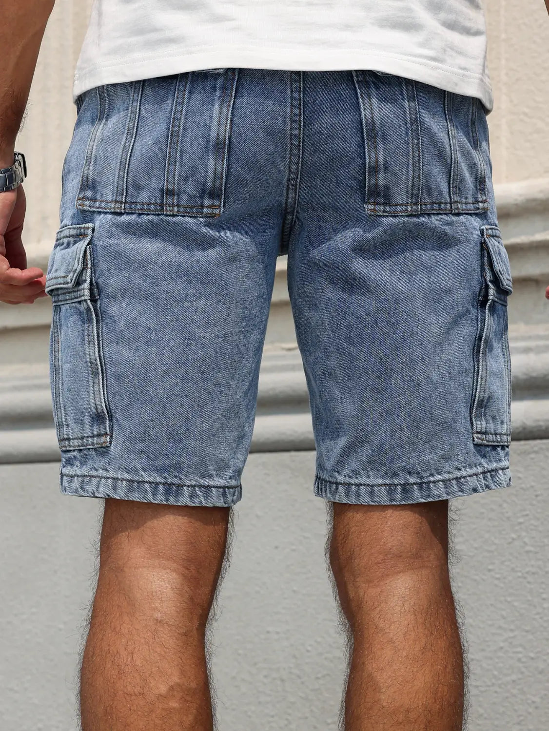 Men blue denim cargo shorts in light wash with multiple pockets and a regular relaxed fit.