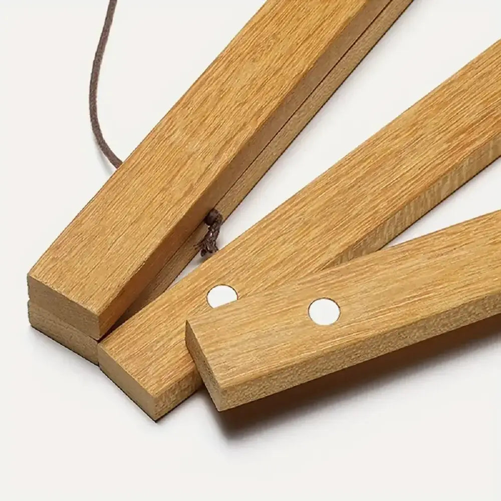 light brown teak wood clapper sticks with smooth natural grain and two white circular holes on each end for a magnetic photo frame poster hanger
