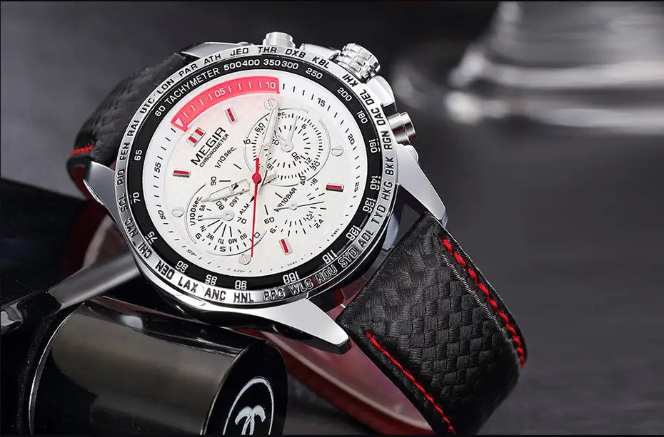 A sleek silver-toned Megir 1010 men quartz chronograph watch with a white dial, red accents on the bezel and hands, and a black carbon-fiber textured strap with contrasting red stitching.