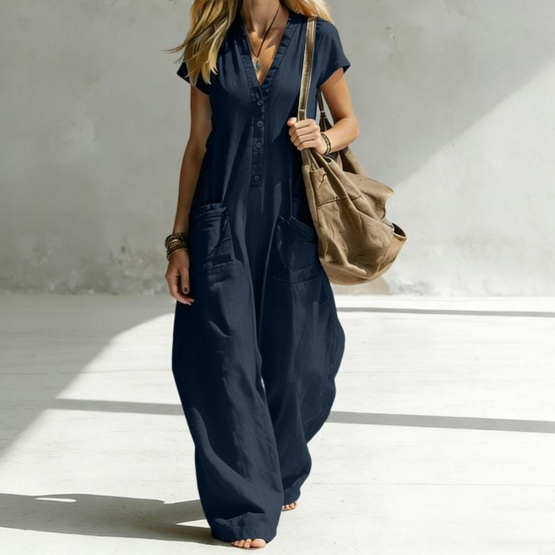 Navy blue button-front wide leg jumpsuit for women featuring front pockets and a comfortable loose fit.