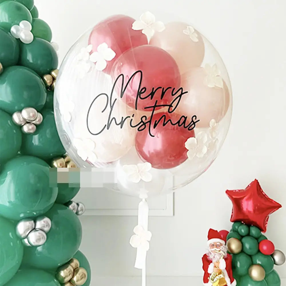 Individueller Baby-Party-Ballonaufkleber auf einem transparenten 36-Zoll-Bobo-Ballon, gefüllt mit roten und rosafarbenen (Blush) Ballons, verziert mit weißen Papierblumen und „Merry Christmas“ in schwarzer geschwungener Handschrift.