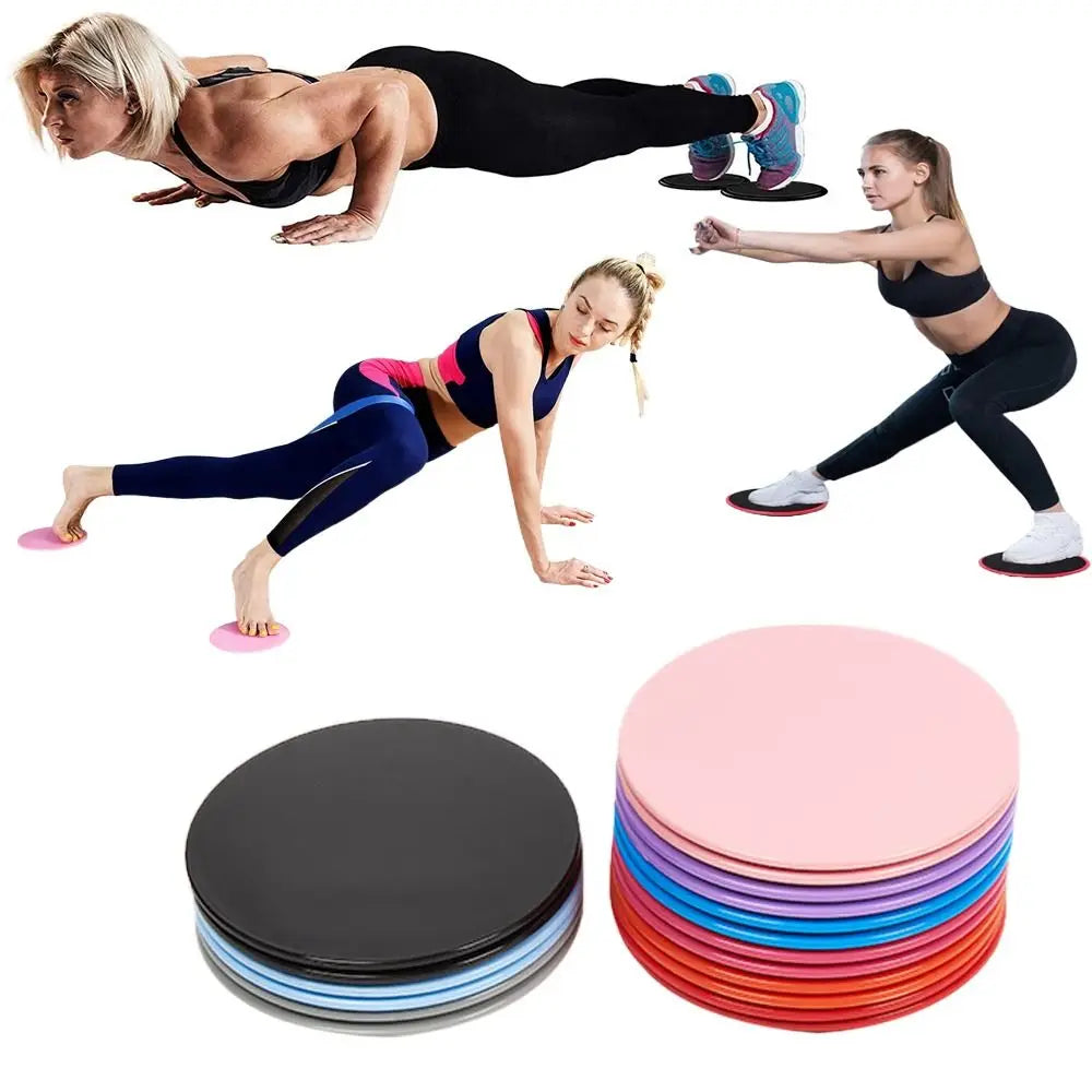 Stacks of colorful core sliders fitness gliding discs in pink black blue purple and red for abdominal training and full body workouts.
