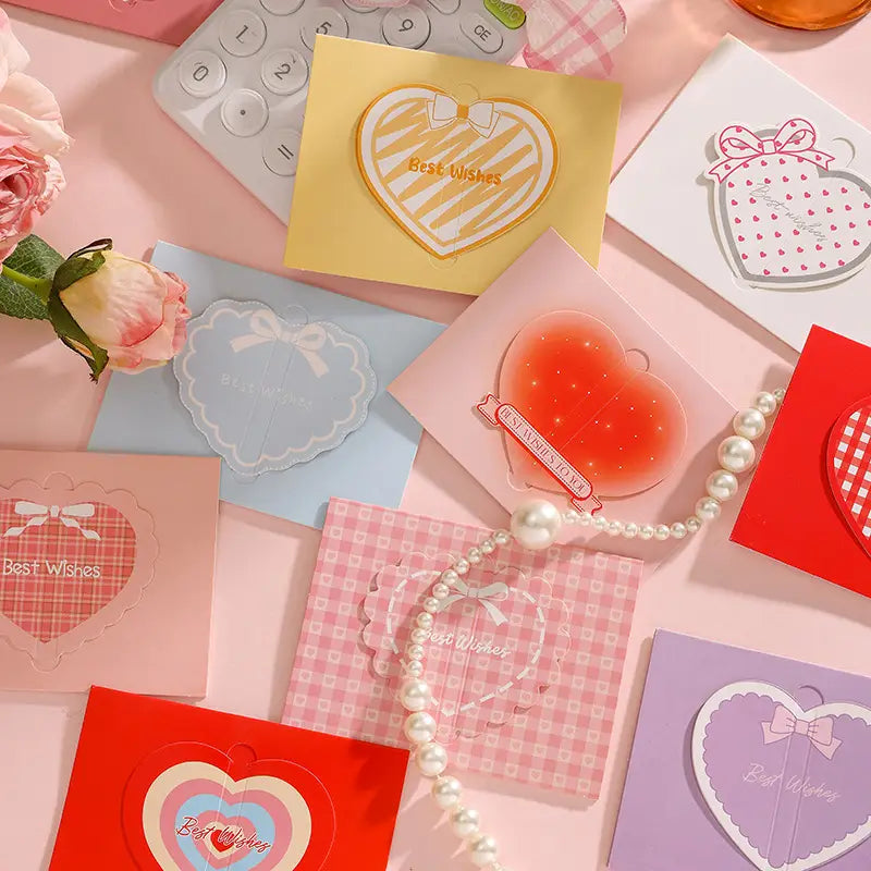 A collection of pastel-colored 3d heart-shaped greeting cards featuring delicate bow designs and best wishes printed in elegant script for valentine wedding notes.