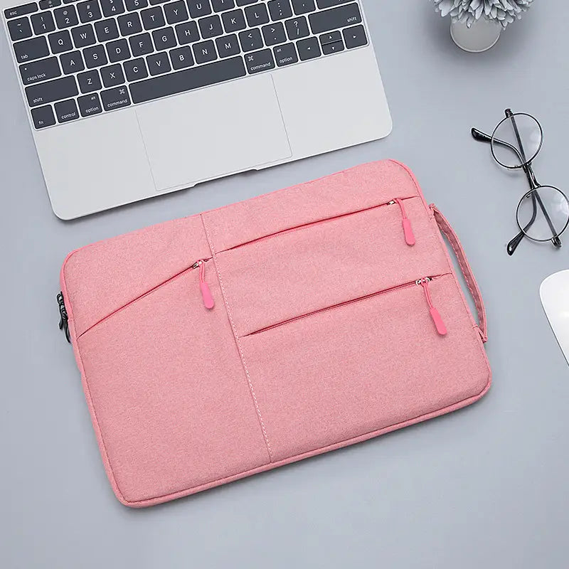 pink laptop sleeve bag for macbook air and pro with multiple zippered compartments and matching pink zipper pulls for organized storage